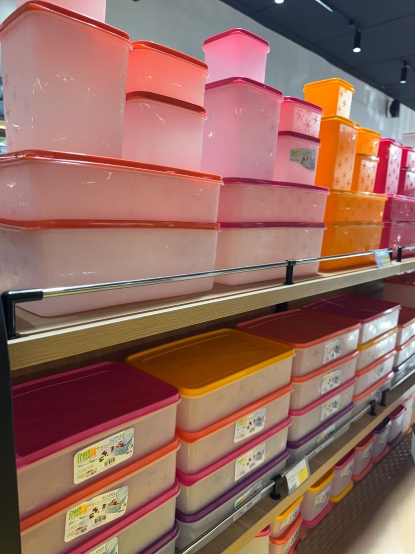 Wall of bright pink and orange freezer boxes